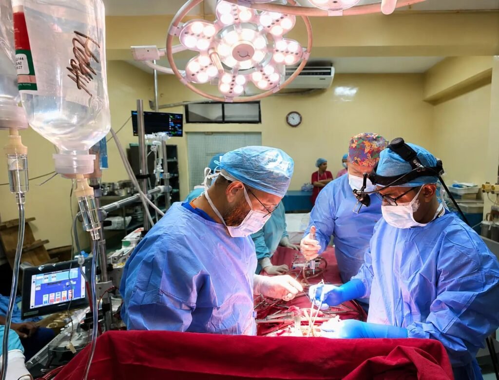 Surgical team performing cardiac surgery under the operating light at NICVD