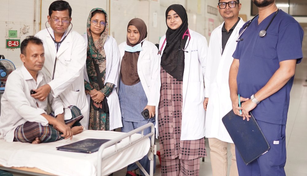 Members of the unit at a patient bedside during a ward round