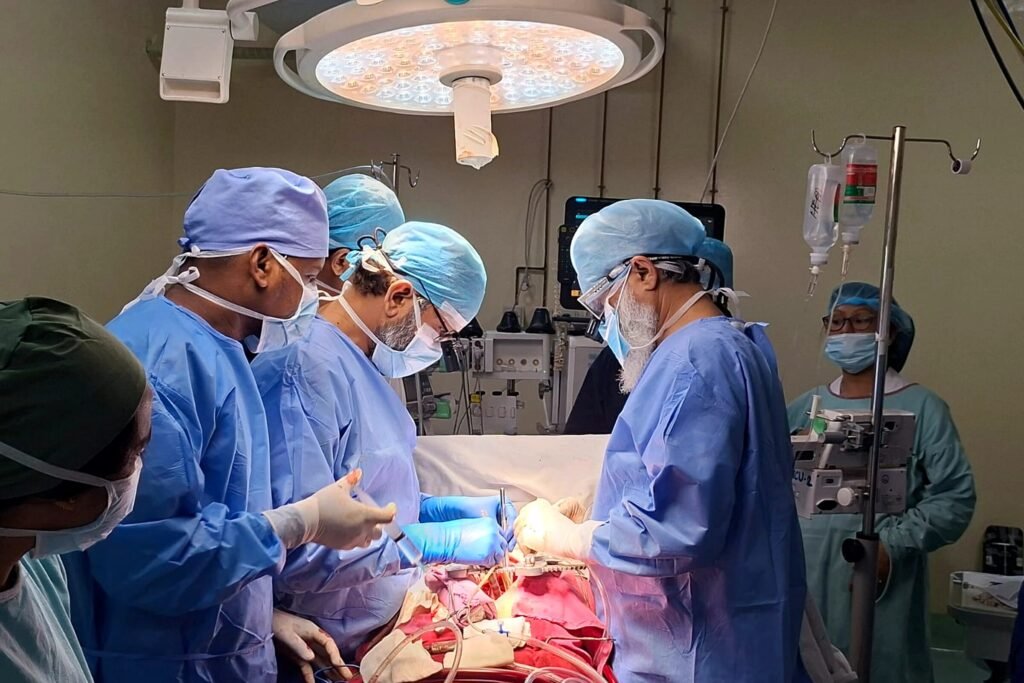 Cardiac surgical team performing an open-heart procedure in the operating theatre, NICVD